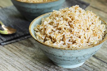 cooking brown rice in a ceramic bowl