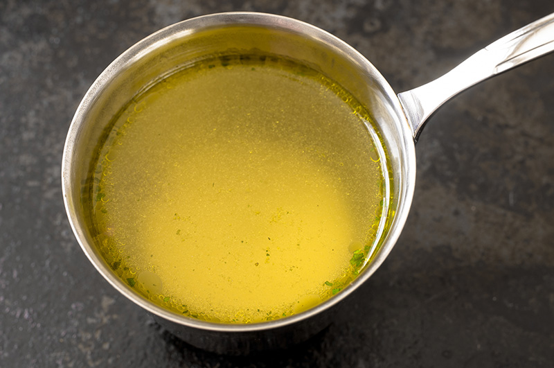 fresh chicken broth in a metal pan