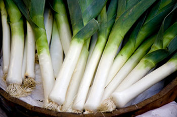 fresh leeks in a wooden basket