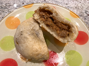 The Beefy Chedd'r Pot Pie from Alpha Foods, after microwaving and cutting in halfs