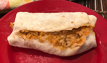 a picture of the Vegan Bean & Rice Burrito from Whole Foods, cooked