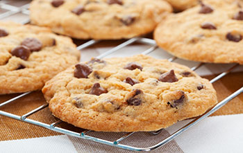 freshly baked chocolate chip cookies on a wire cooling rack