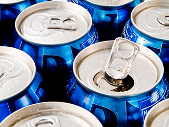 the tops of several soda cans - one is opened